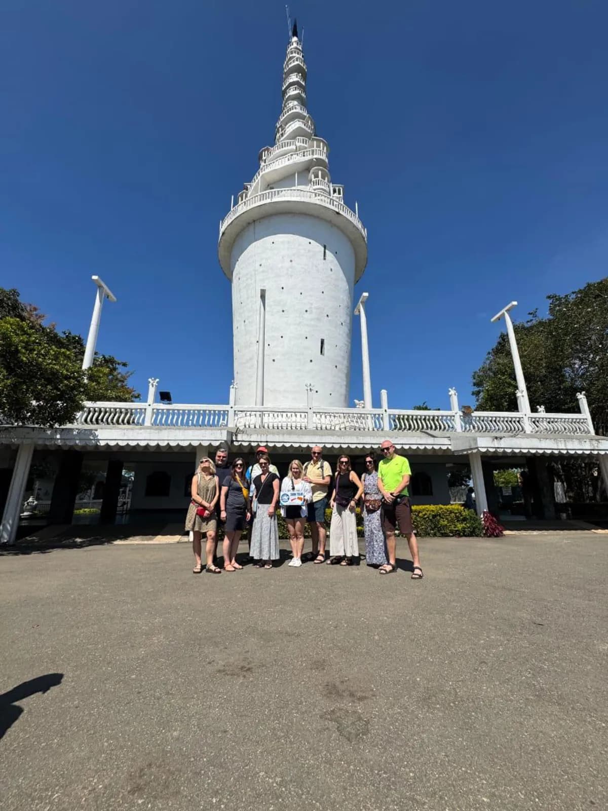 A group gathered at the foot of Ambuluwawa Tower