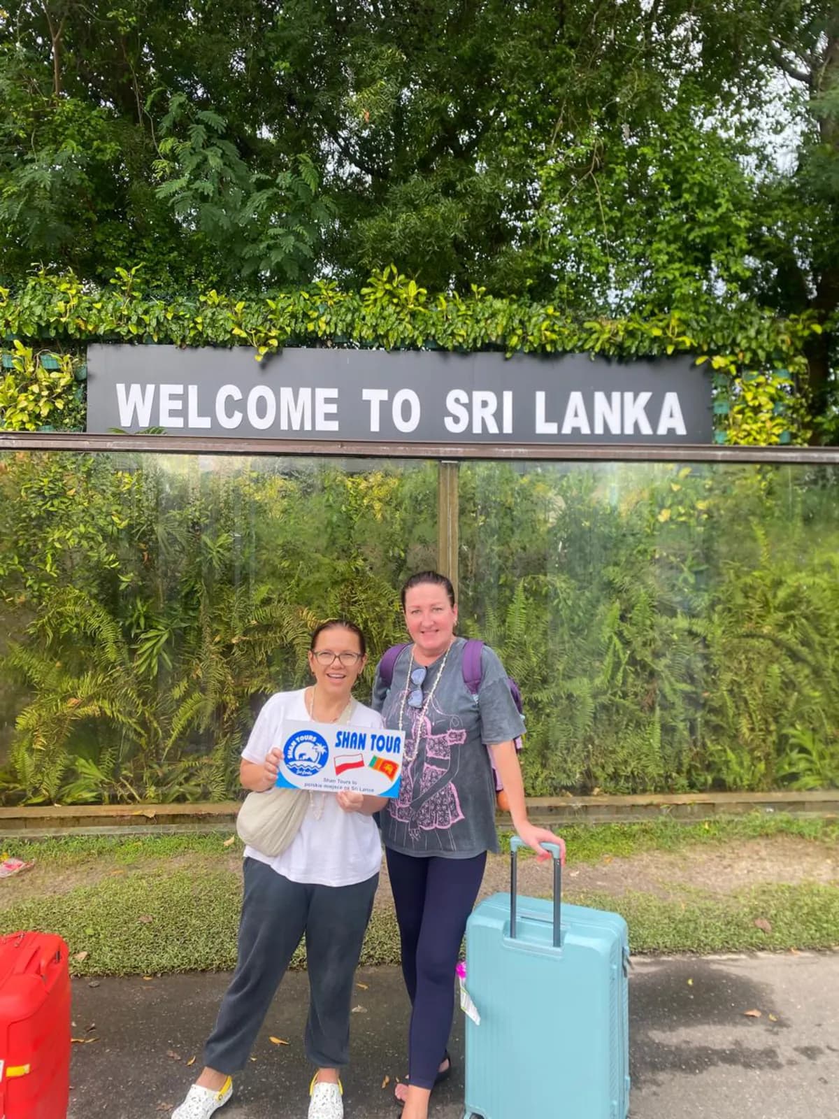 Travellers arriving at the Welcome to Sri Lanka sign