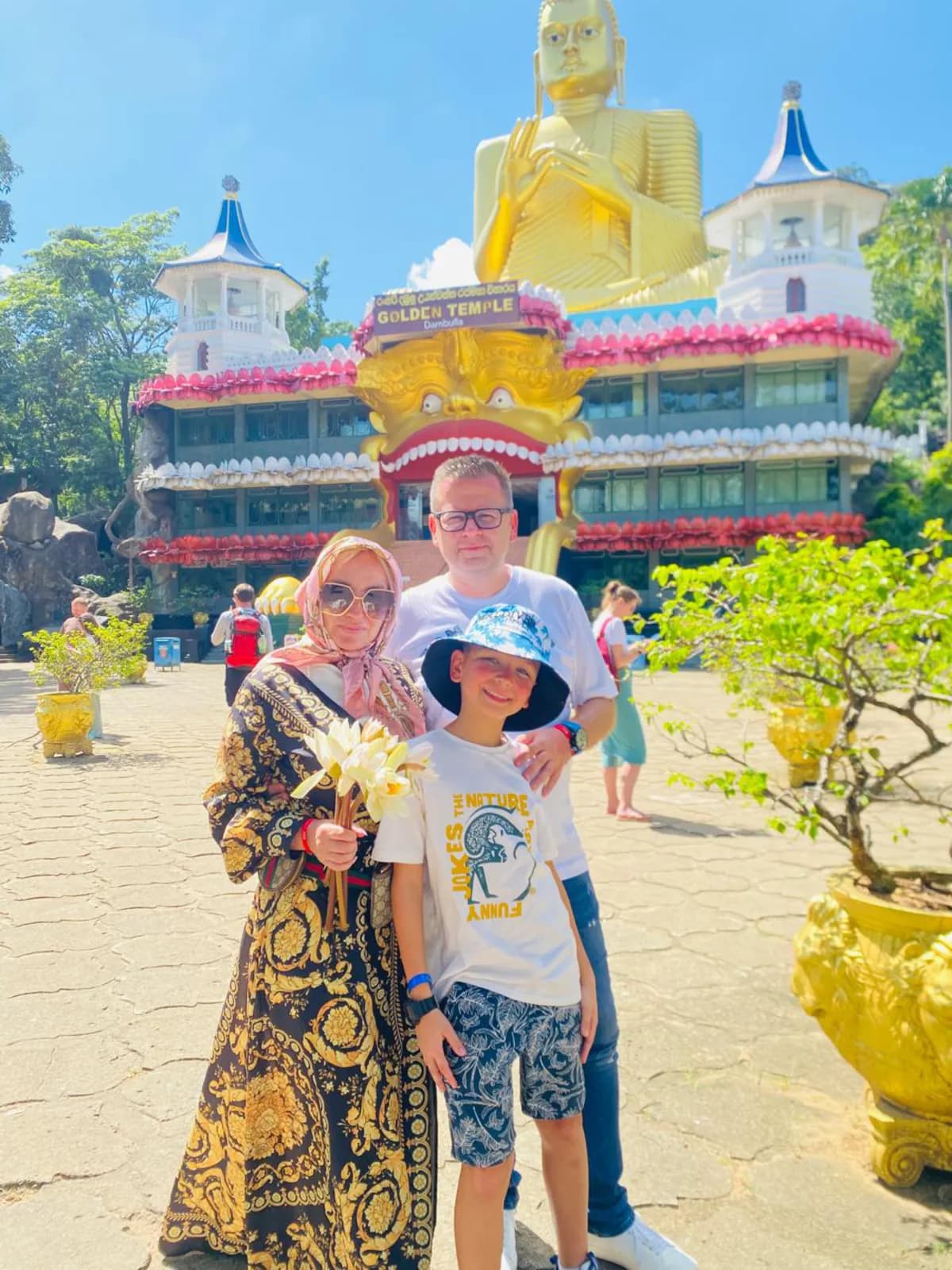 A family in front of the Dambulla Golden Temple