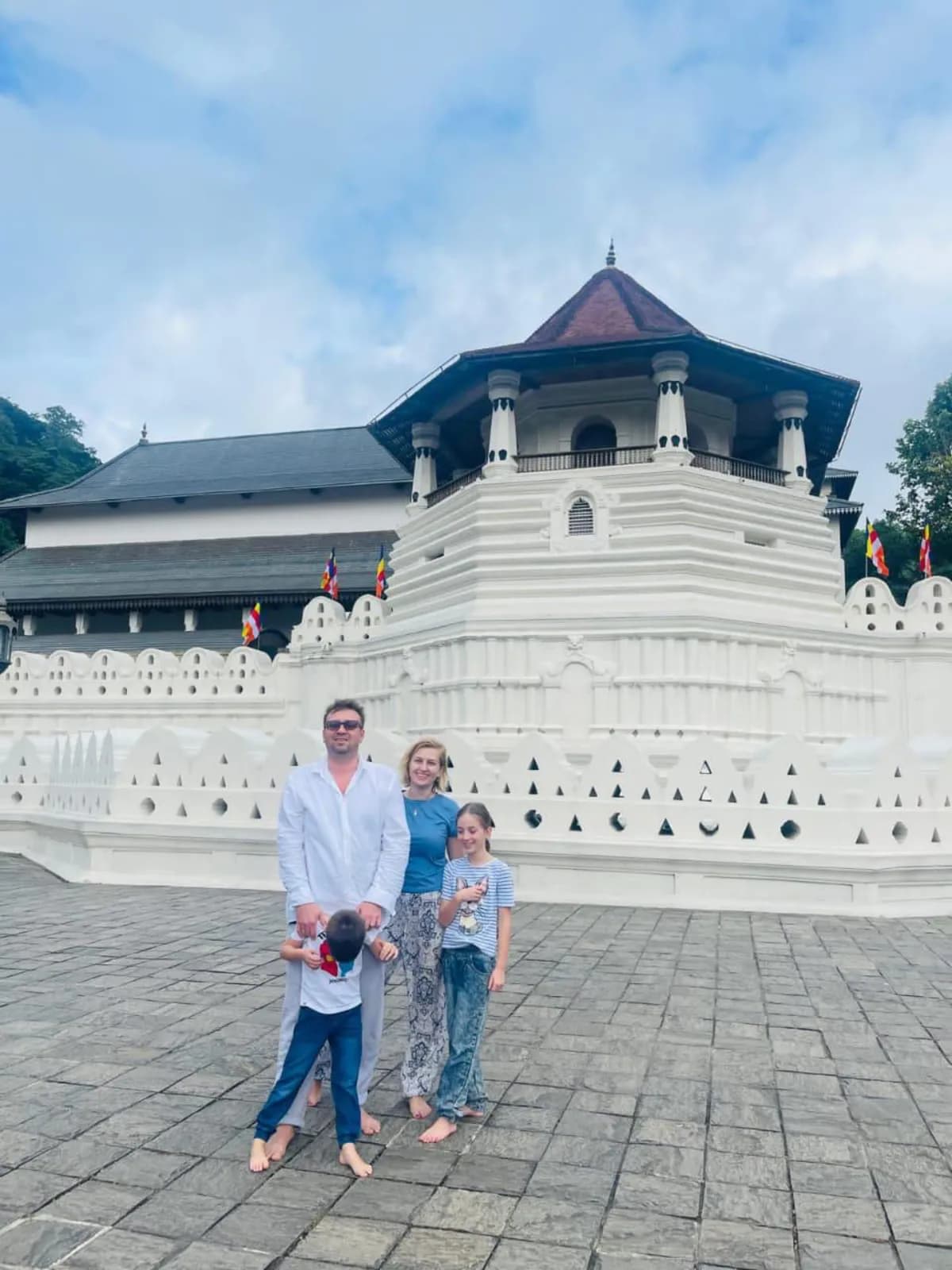 A family outside the Temple of the Sacred Tooth Relic in Kandy