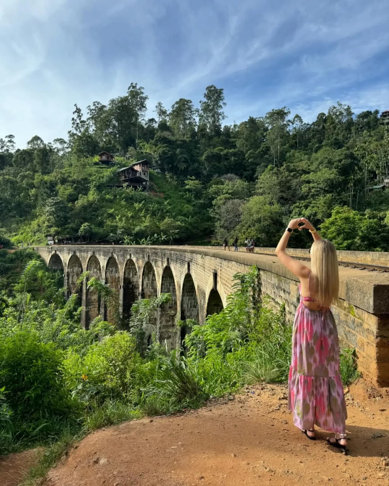 A traveller photographing Nine Arch Bridge from the trail