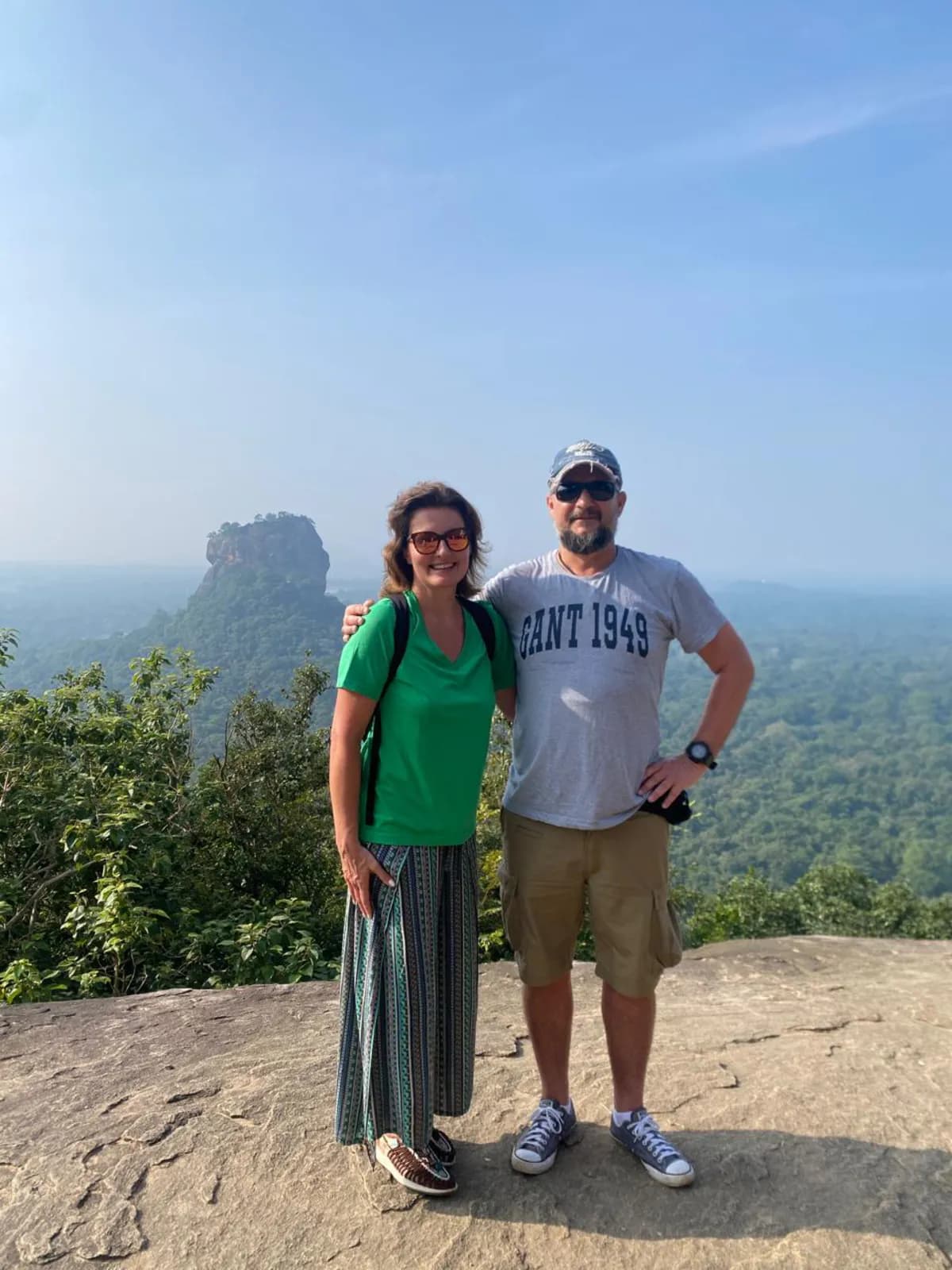 A couple on Pidurangala rock with Sigiriya in the distance