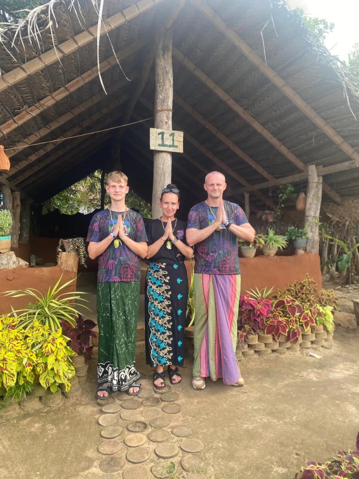 Travellers welcomed in traditional dress at a village stop